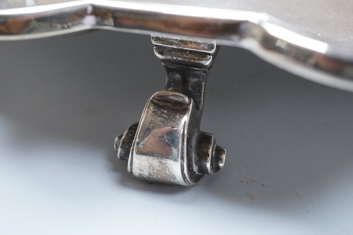 A George V silver salver, by Thomas Bradbury & Sons, of shaped circular form with reeded border and engraved initial, on three scroll feet, Sheffield, 1930, diameter 30.5cm, 33.1oz.